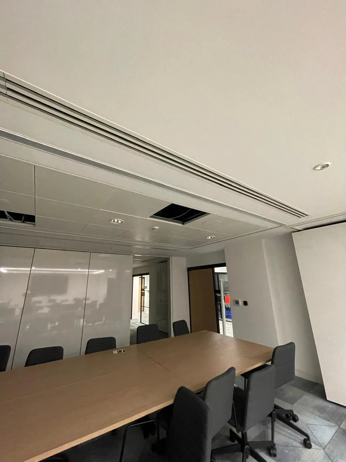 Completed meeting room with visible ceiling services