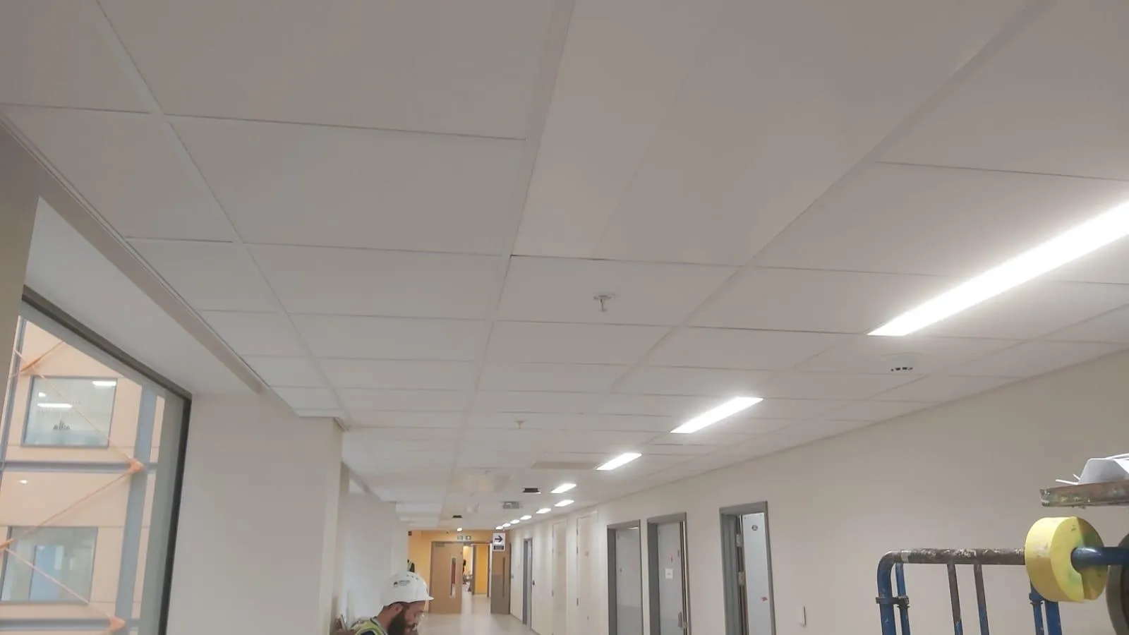 Completed institutional corridor ceiling in a wide view